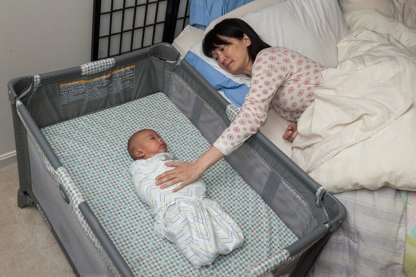 baby bed next to parents