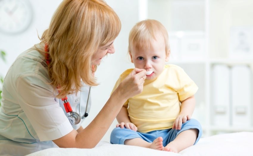 doctor giving medicine to child